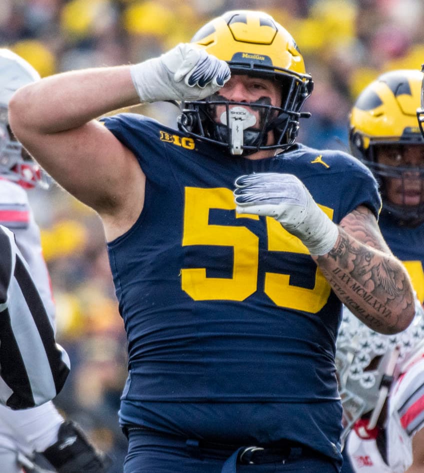 Mason Graham in a Michigan uniform, No. 55, celebrating a play.