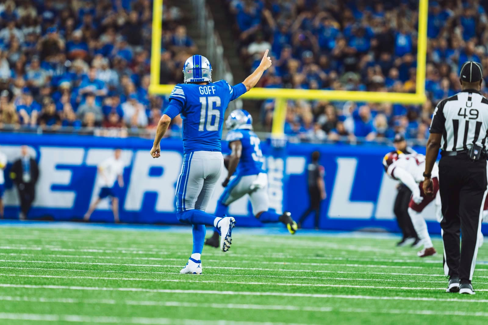 Jared Goff in a Lions uniform on the field at Ford Field.